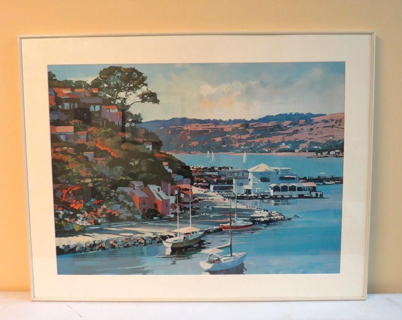 Coastal painting: Boats in a harbor, buildings on a hillside, blue water, green trees, white frame.