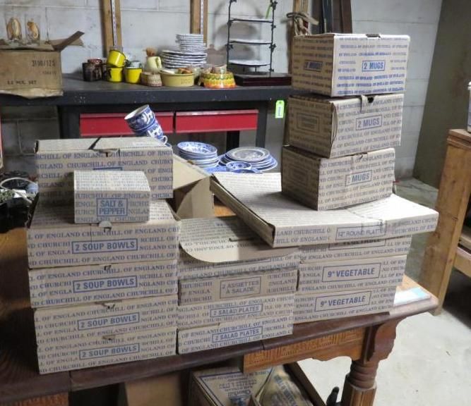 Boxes of soup bowls and vegetables stacked on a wooden table.