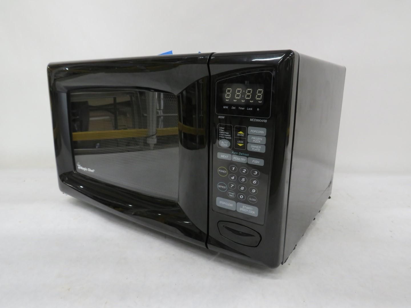 Black microwave oven with digital display and keypad on a white surface.