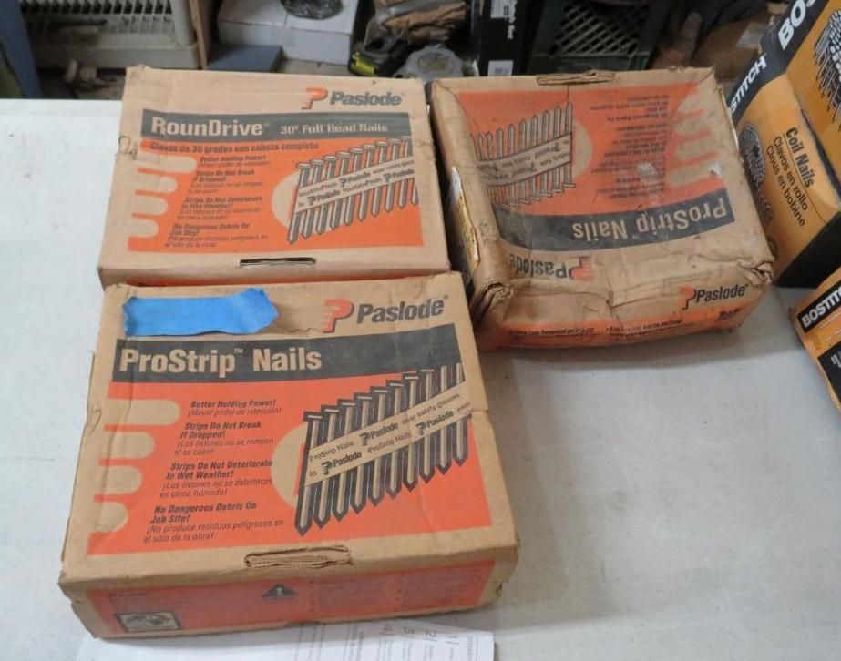 Boxes of Paslode ProStrip nails and RoundDrive nails on a surface.