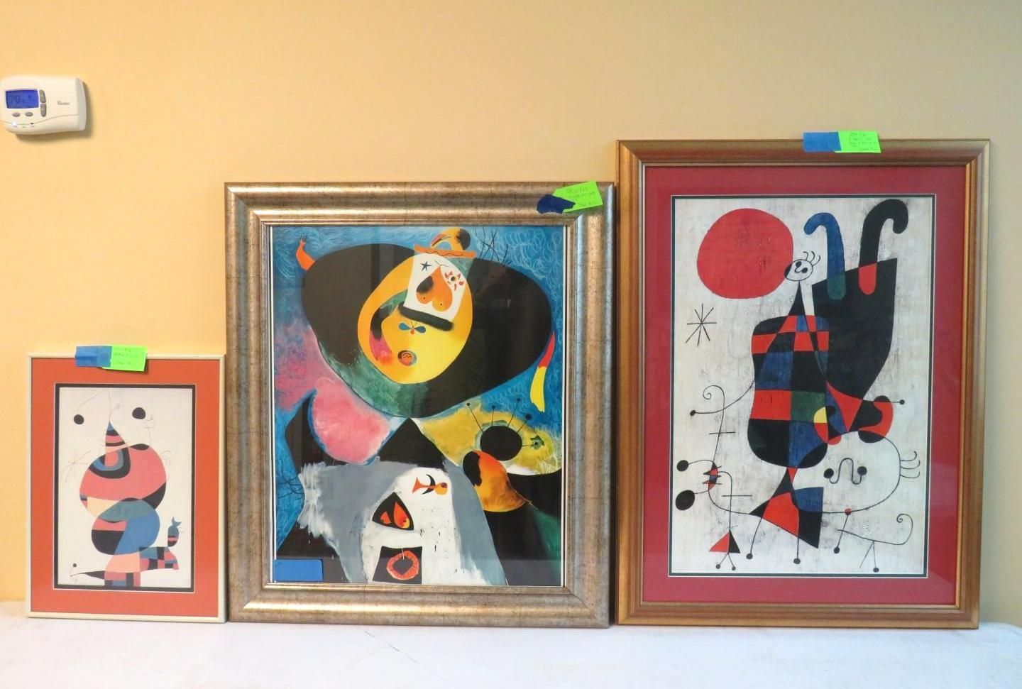 Three framed abstract art prints with bright colors.
