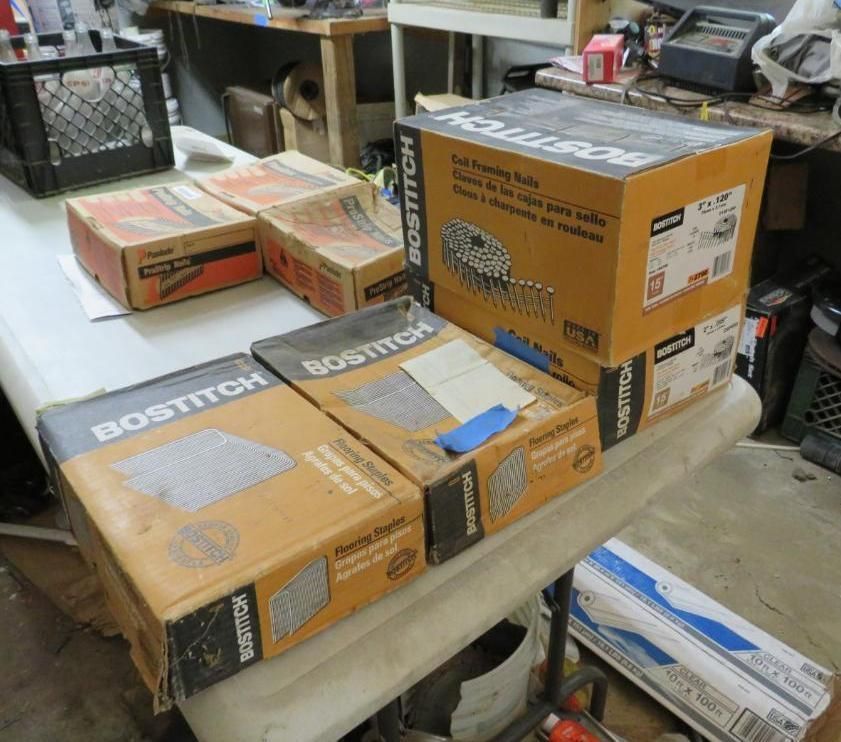 Boxes of Bostitch nails and fasteners on a table in a workshop setting.