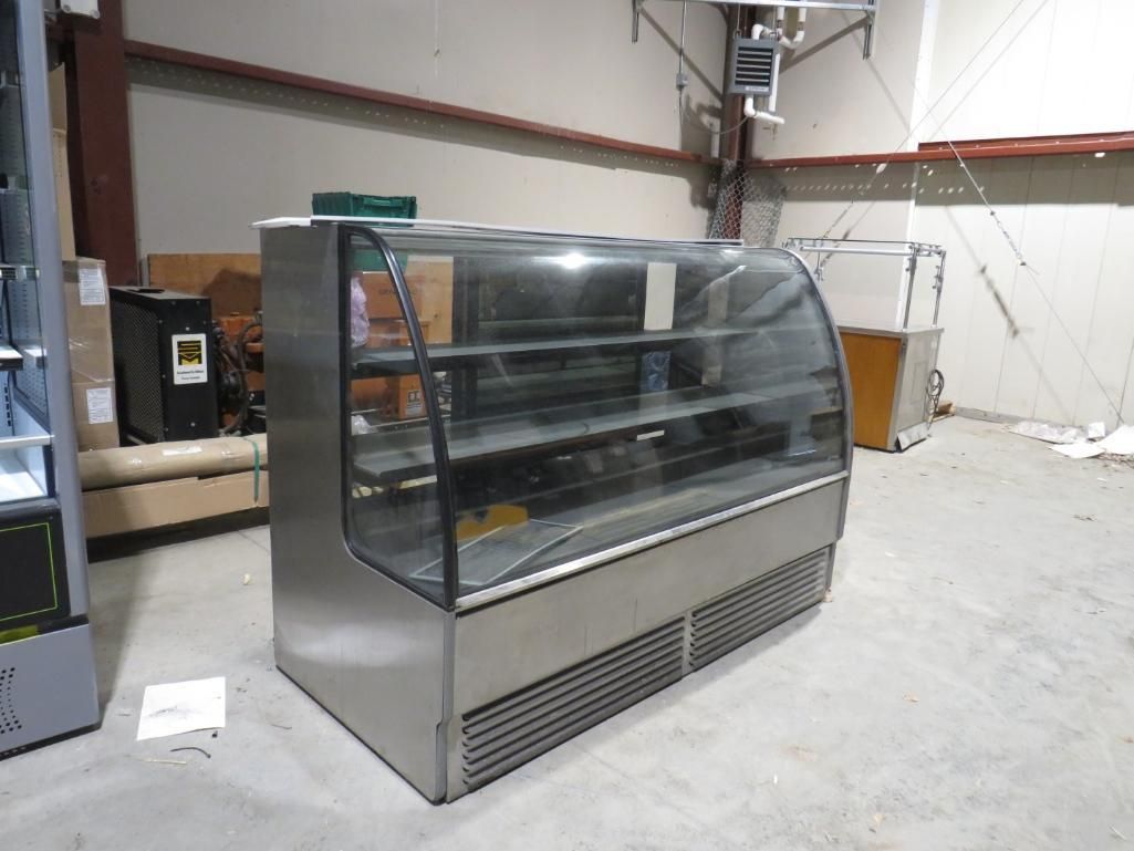 Stainless steel bakery display case in a warehouse setting.