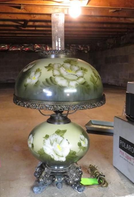 Antique glass lamp with hand-painted floral design; green and white, ornate metal base.