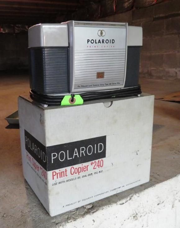 Polaroid Print Copier 240 on its box. Silver, gray, and white machine with a black cord, indoors.