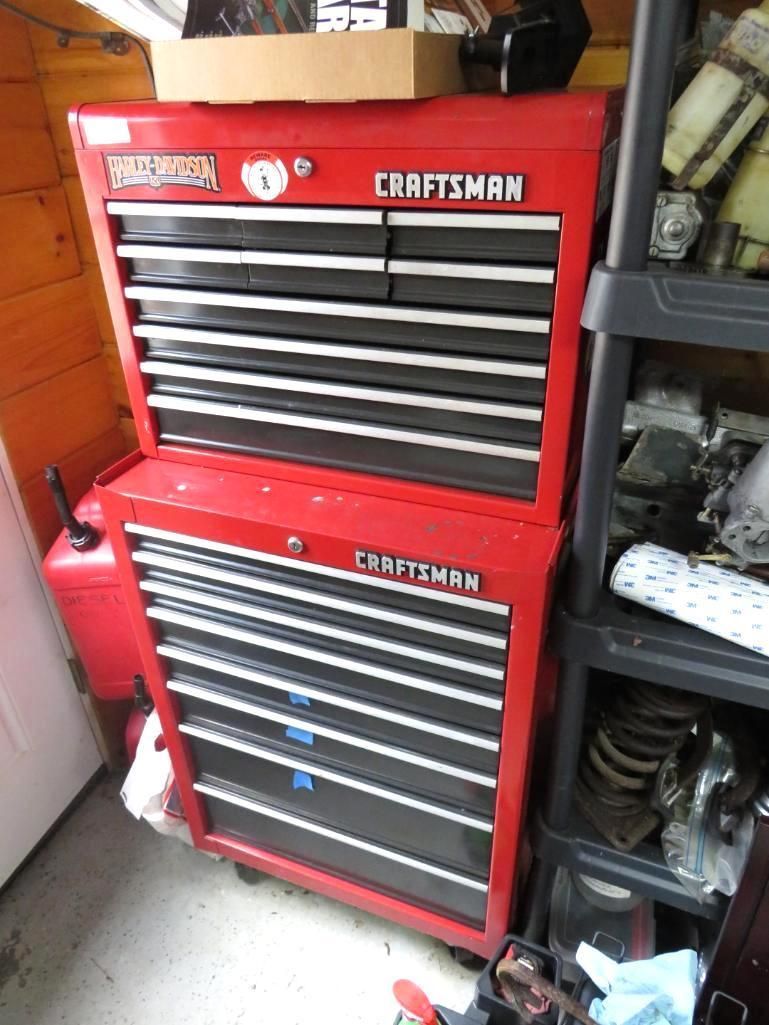 Red Craftsman tool chest, two-piece stack, black drawers, in a garage.