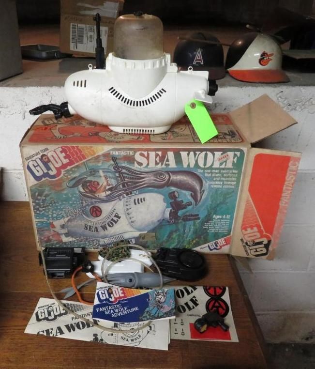 Vintage G.I. Joe Sea Wolf submarine toy with original box and accessories, white and orange.