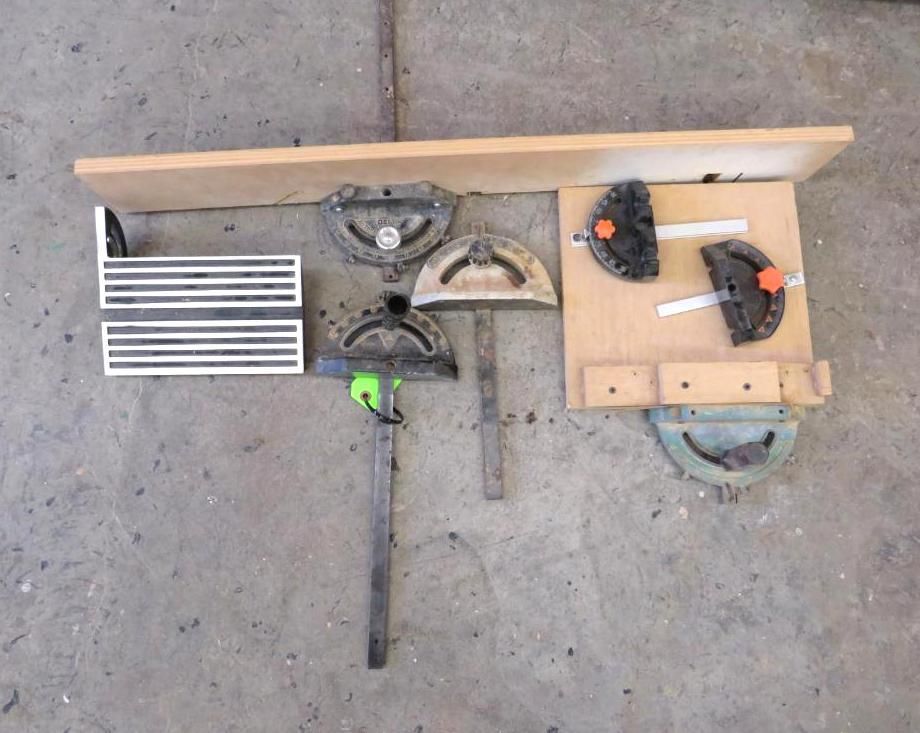 Assorted woodworking jigs and angle finders arranged on a concrete surface.