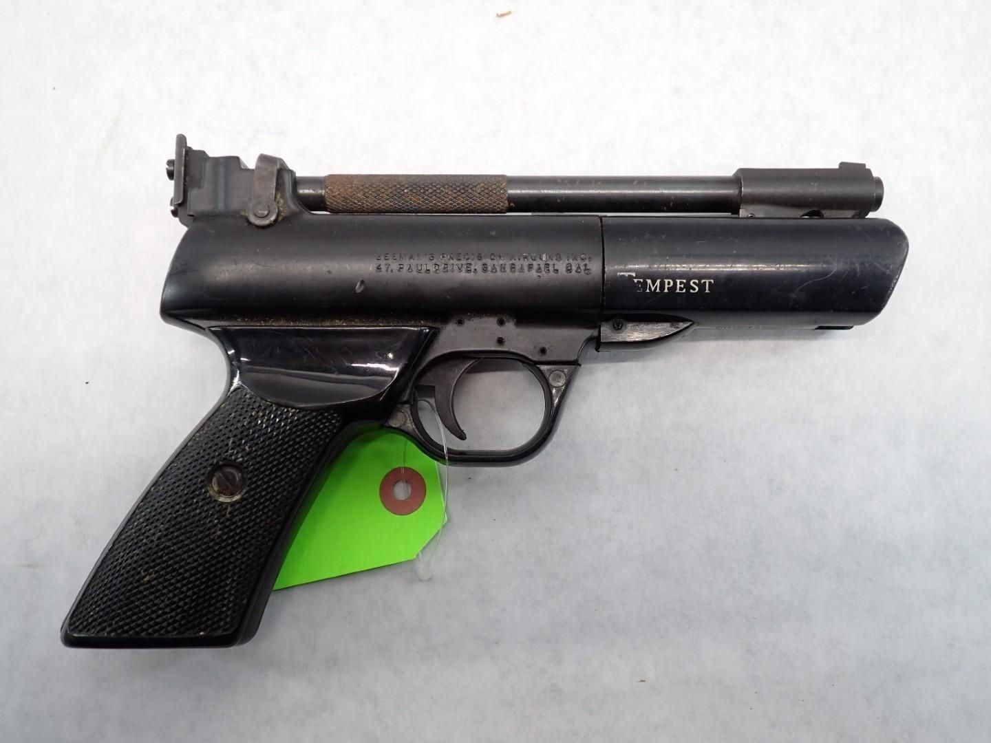 Black air pistol with checkered grip, brown barrel.