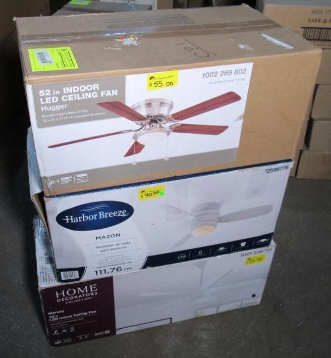 Three boxes of ceiling fans stacked, each with price tags visible.