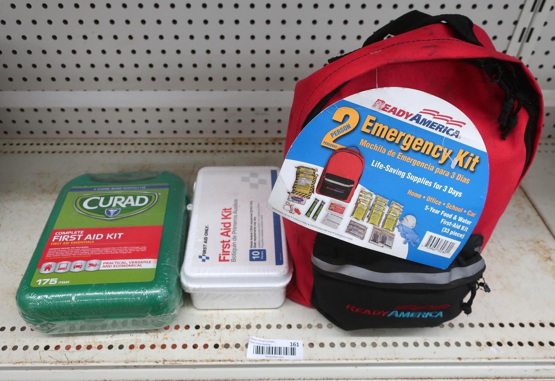 First aid and emergency kits on a store shelf. Includes Curad, Sam's Club, and Ready America kits.