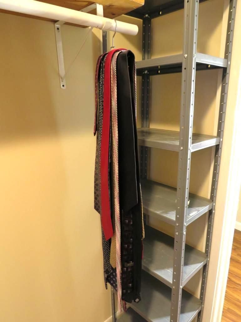 Closet with metal shelving and hanging scarves. Beige walls, wooden floor.