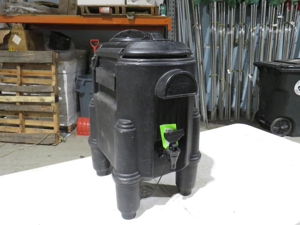 Black compost tumbler with legs and spigot.