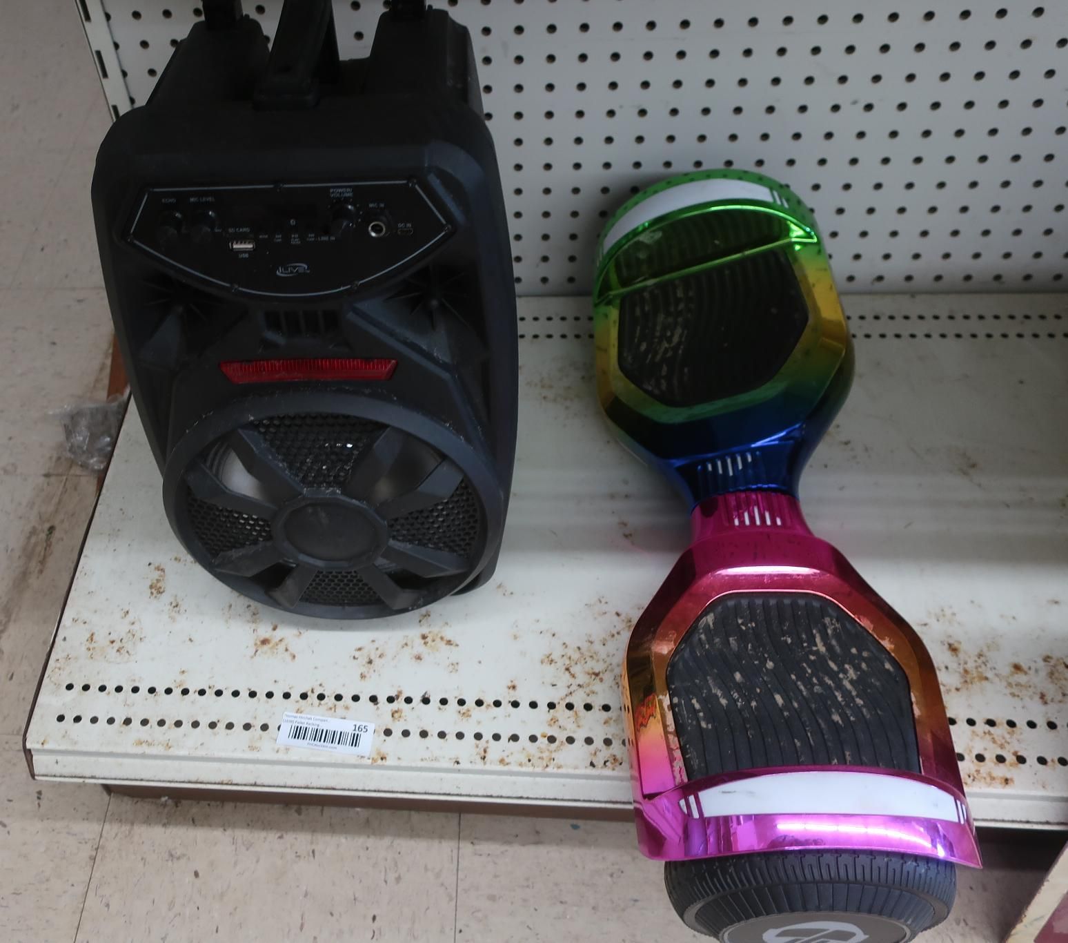 Black speaker and colorful hoverboard on a shelf.