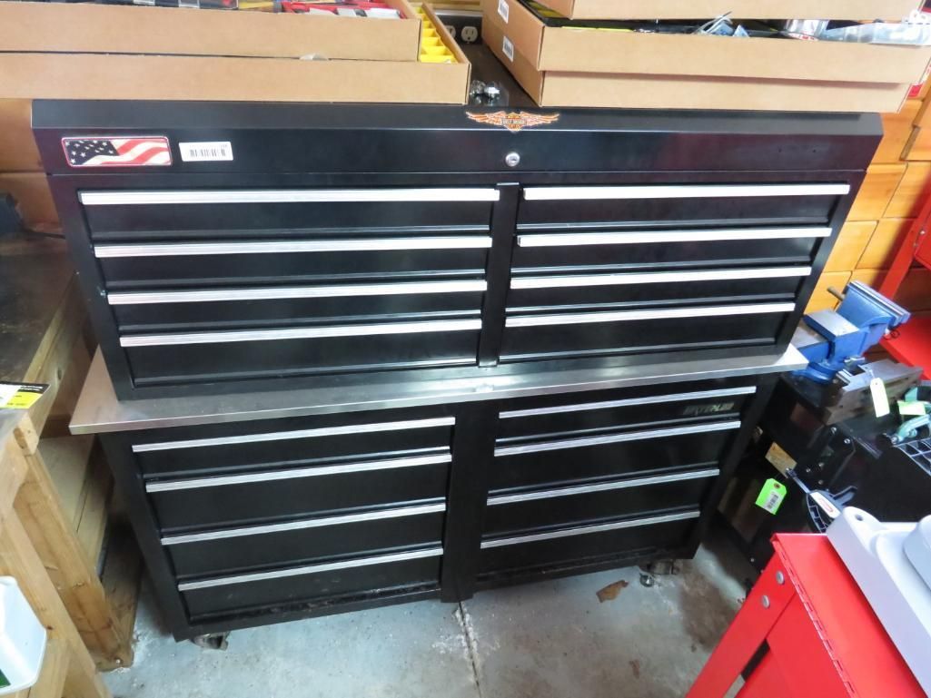 Black tool chest with multiple drawers, in a garage or workshop setting.