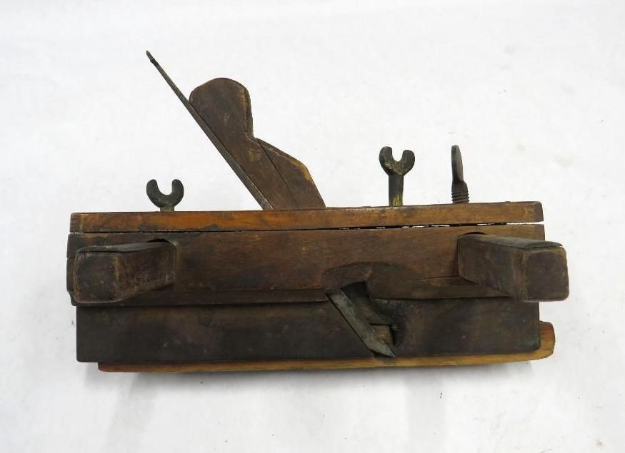 Wooden rabbet plane with metal blade, adjustment screws, and fence.