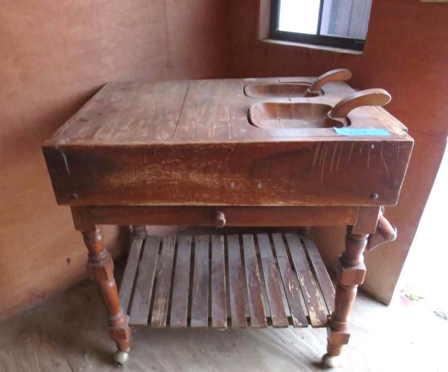 Wooden double sink vanity with decorative legs, a shelf, and one drawer.