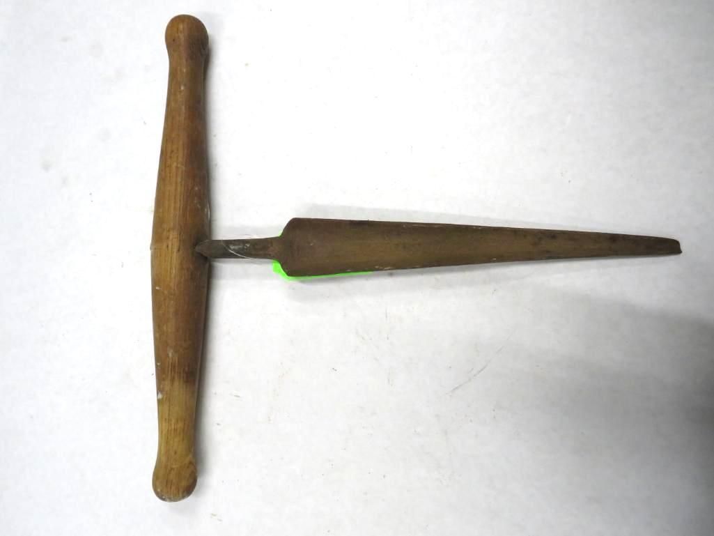 Wooden T-handle awl with a long, tapered metal point.