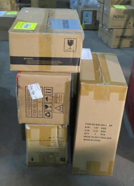 Stack of cardboard boxes, various sizes. Some have labels and shipping tape. Boxes are on a warehouse floor.