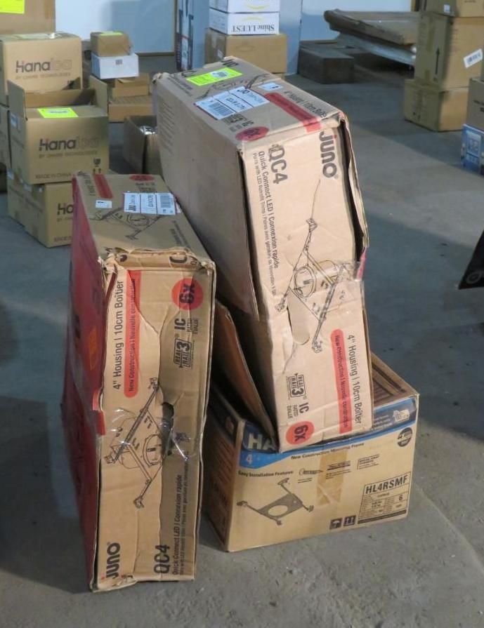 Pile of damaged cardboard boxes, potentially containing furniture, in a storage area.