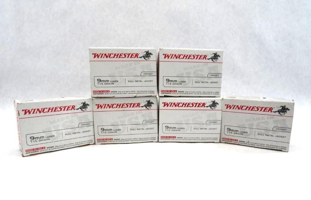 Six boxes of Winchester ammunition, stacked and displayed. White boxes with red text and logo.