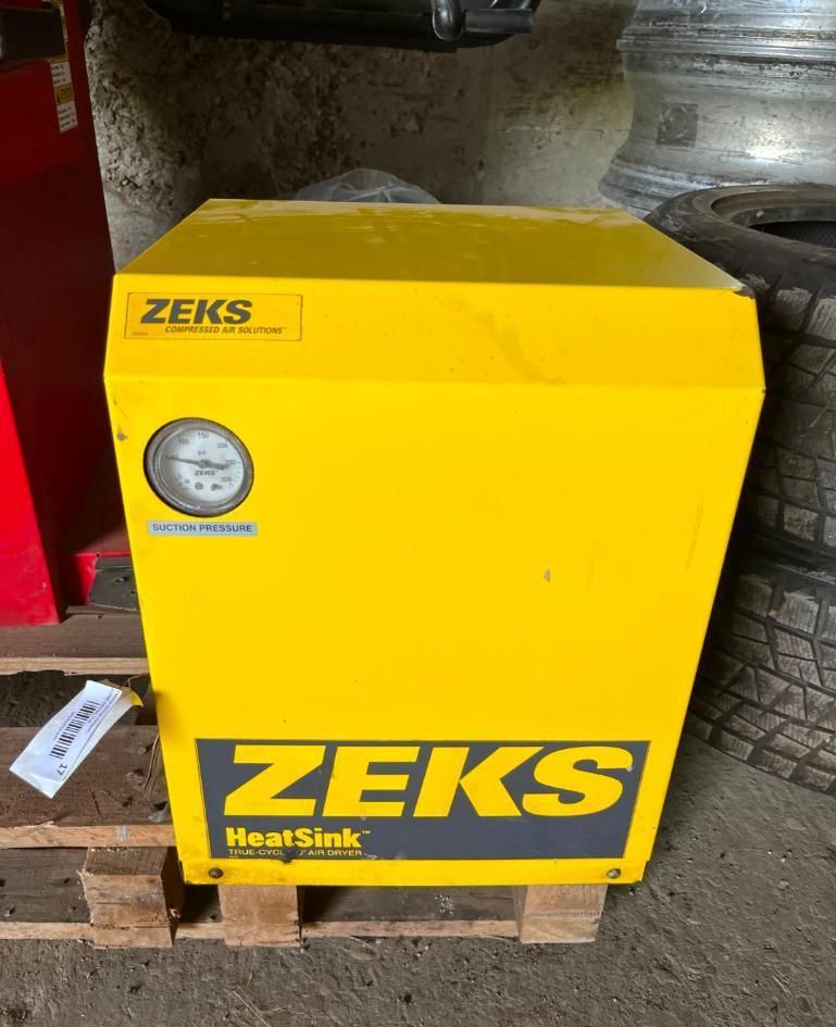 Yellow Zeks HeatSink industrial unit with pressure gauge on a wooden pallet.