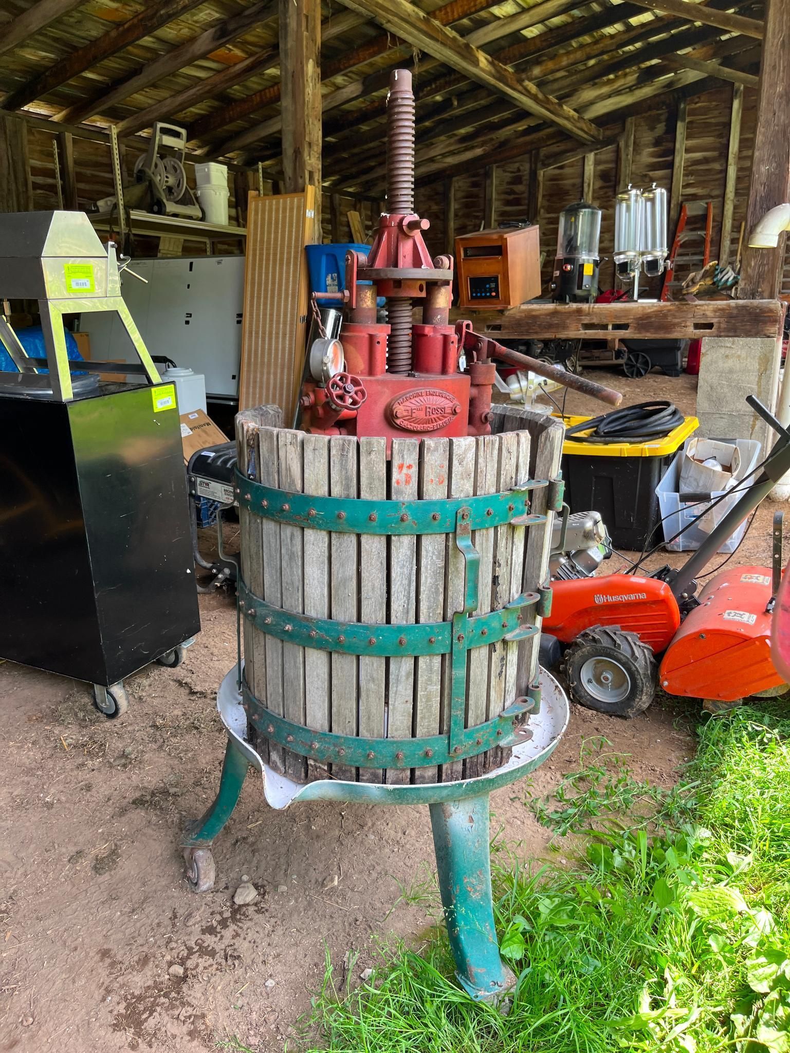 Red and green fruit press in a shed.