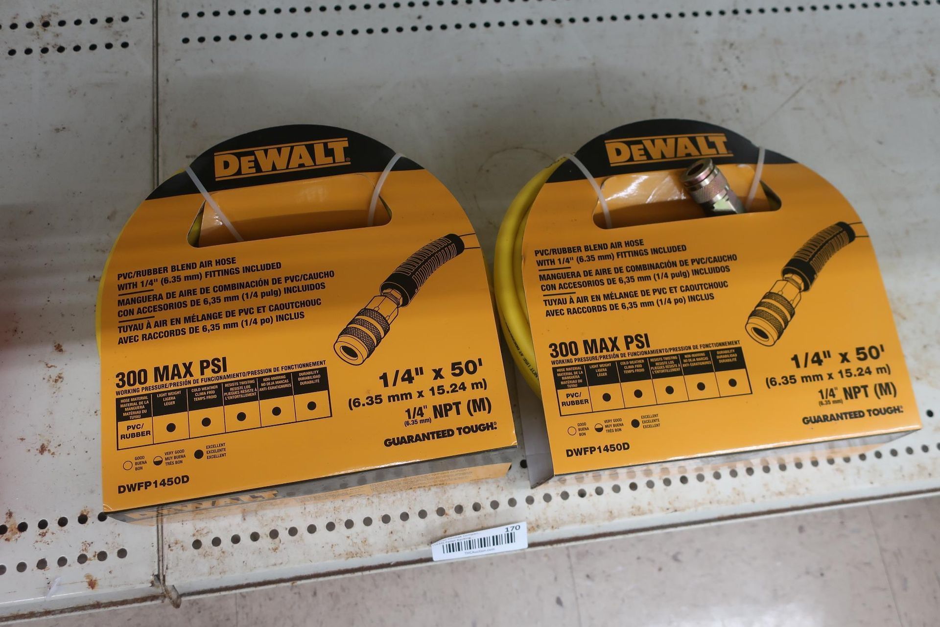 Two DeWalt air hoses on display, each packaged in yellow with product details visible.