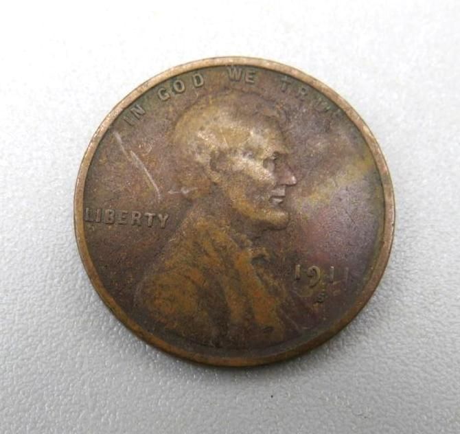 A copper-colored penny featuring a profile of Abraham Lincoln; visible text includes