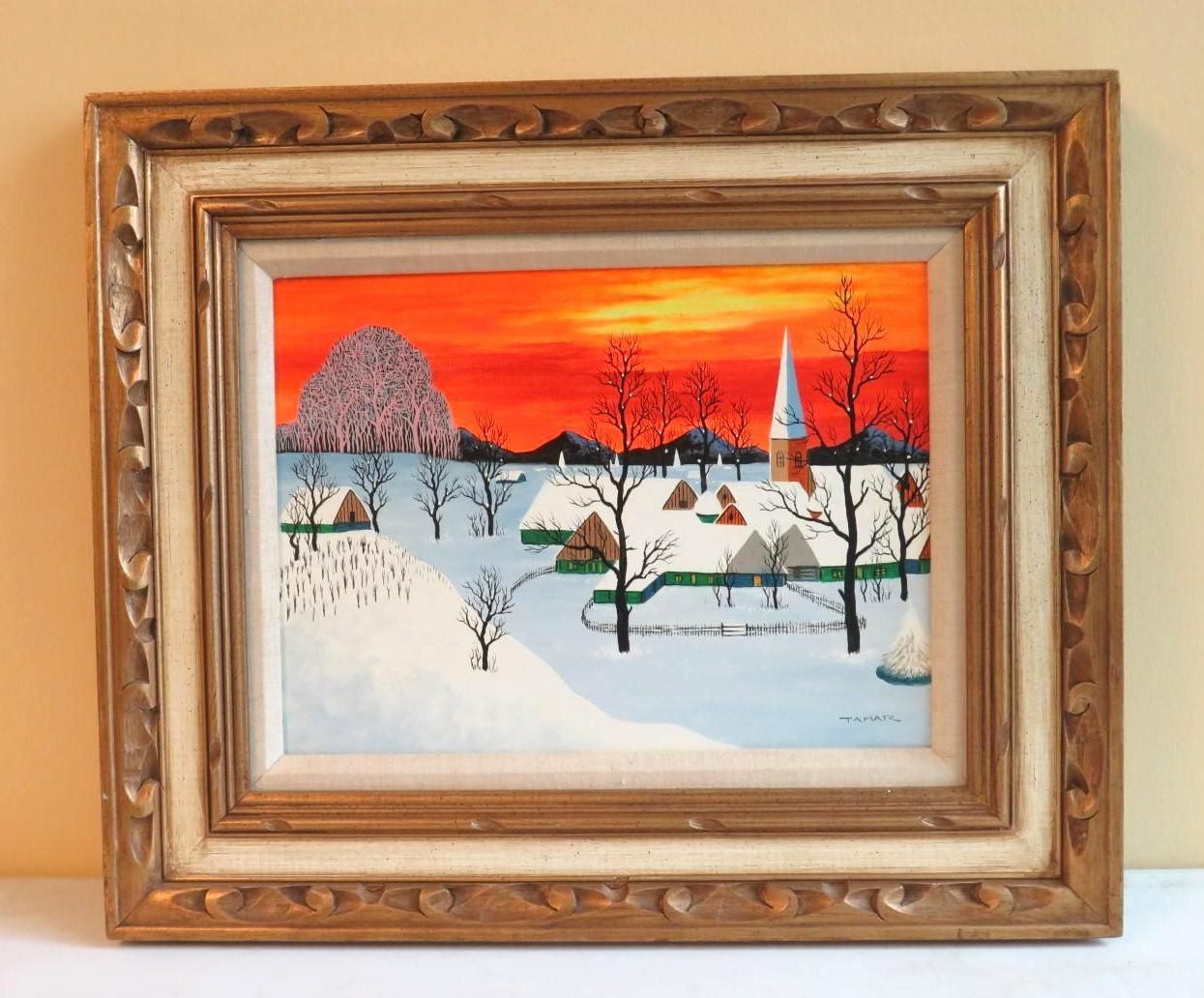 Winter landscape painting in ornate gold frame, snow-covered village, orange sunset.