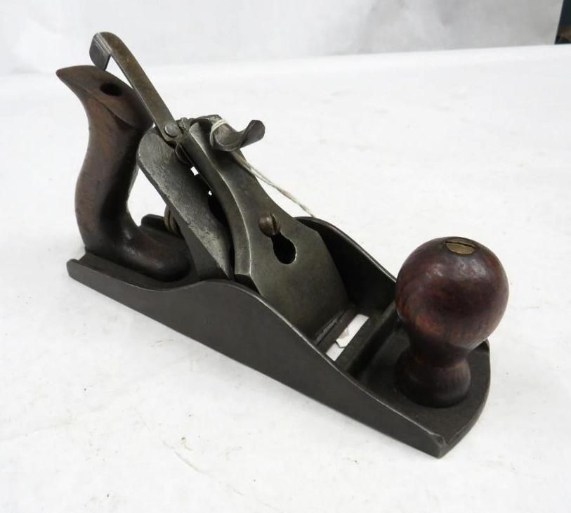 Hand plane with dark wood handle and knob, metal body.