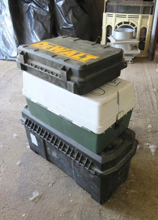 Three stacked toolboxes: black top, white/green middle, and black bottom.