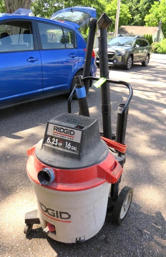 A Ridgid wet/dry vacuum cleaner on wheels, outdoors.