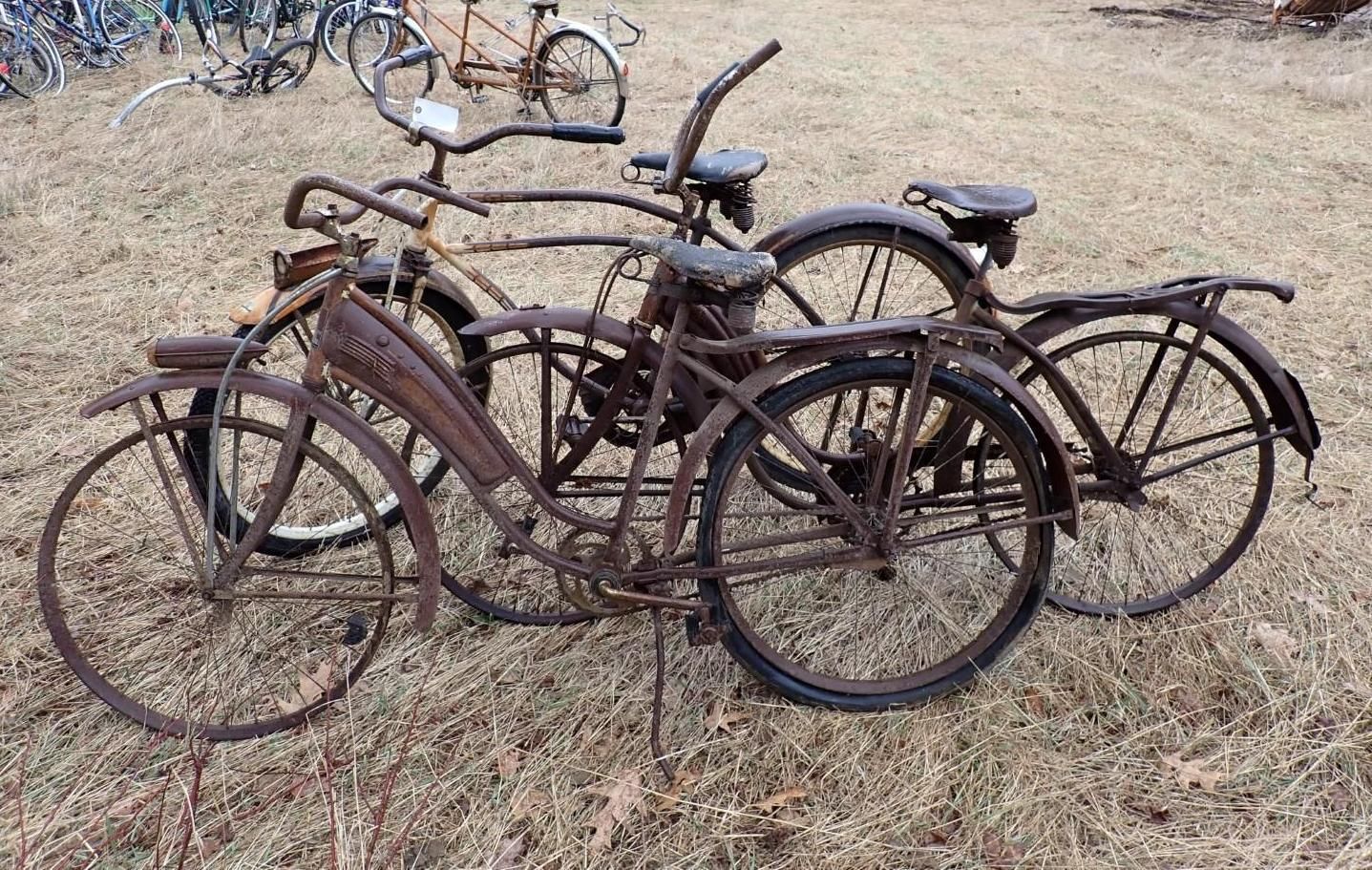Three vintage bicycles parked.