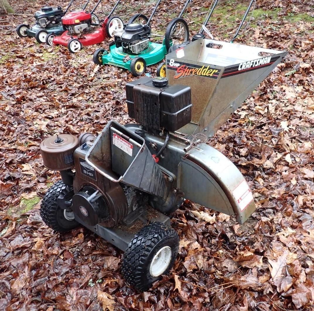 A Craftsman wood chipper sits in a field.