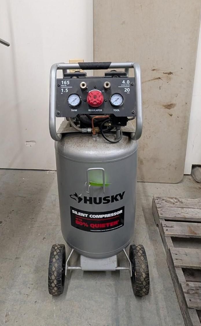 Gray Husky air compressor with black control panel and red knob