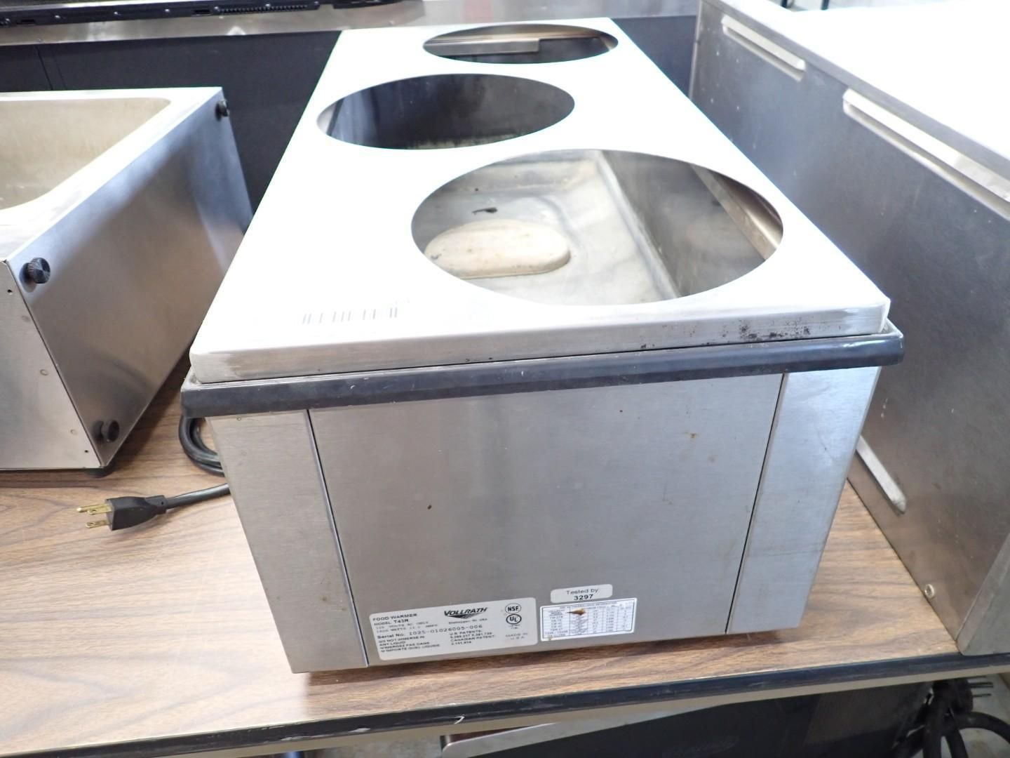 Stainless steel countertop box with three circular cutouts on a workbench