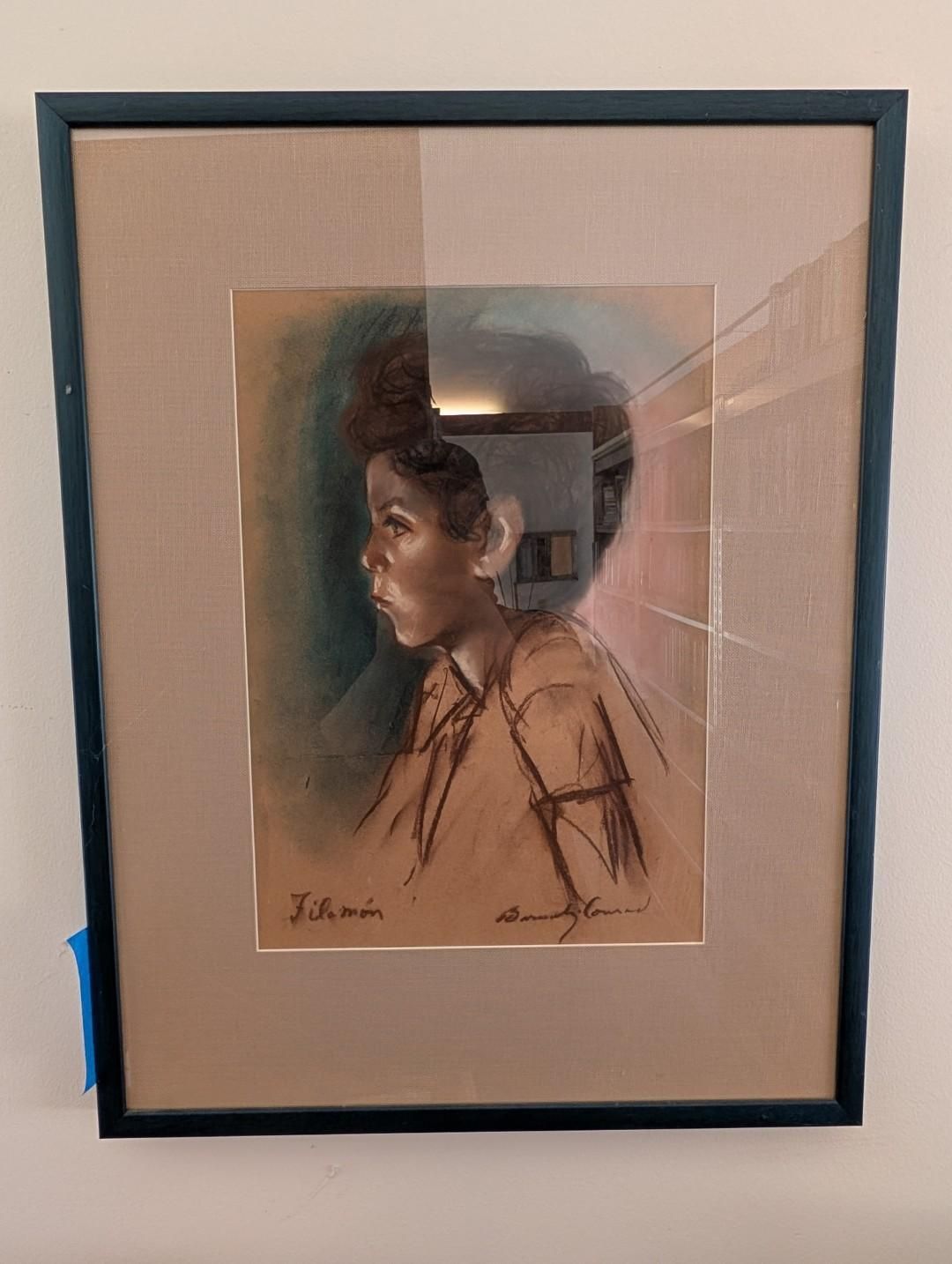 Framed charcoal and pastel sketch of a person in profile, set against a tan background with a signature at the bottom.