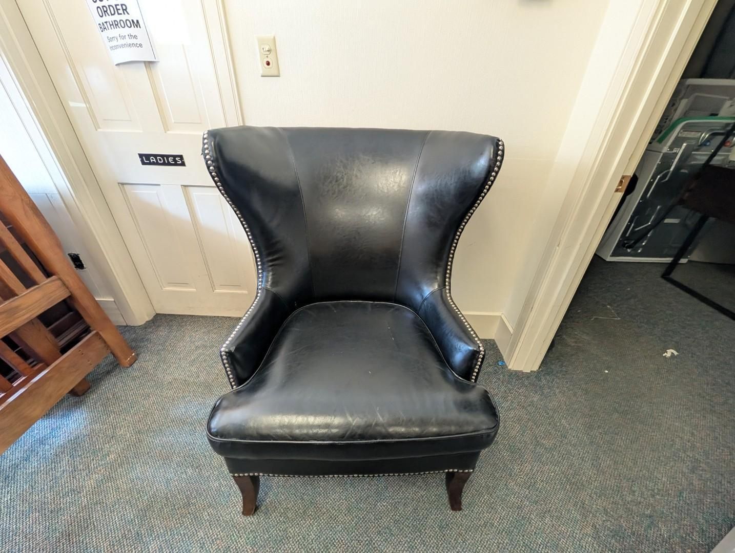 Black leather armchair with wooden legs