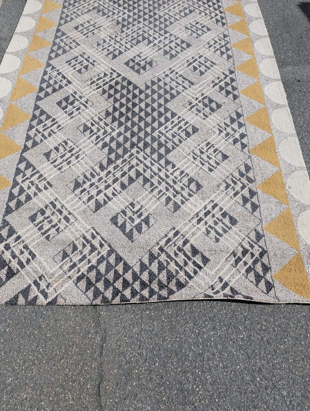 Yellow, white, and gray patterned rug with diamond motifs