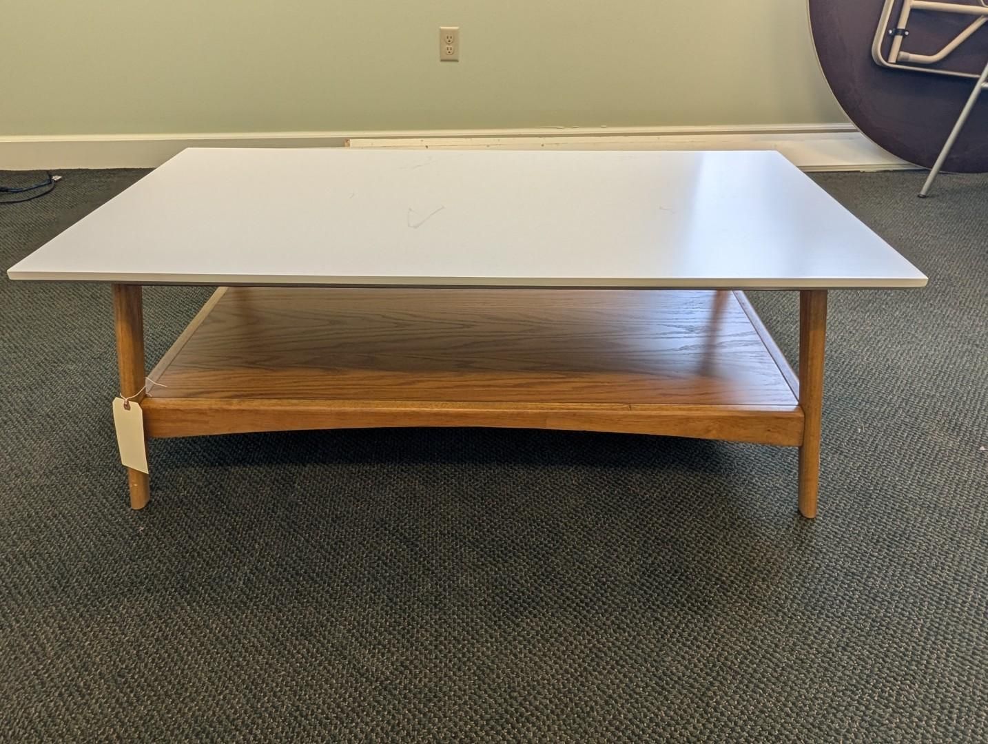 Low coffee table with white top, wooden lower shelf
