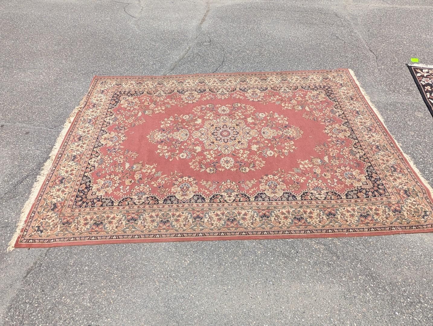 A red patterned rug laid flat