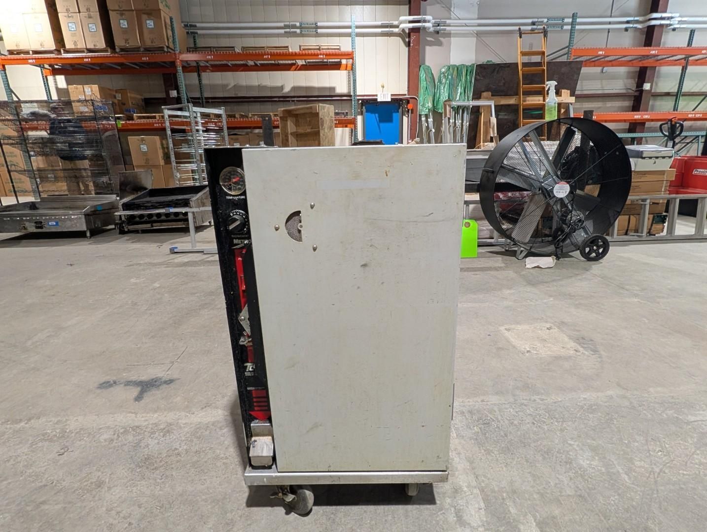 White industrial cabinet on a pallet in a warehouse