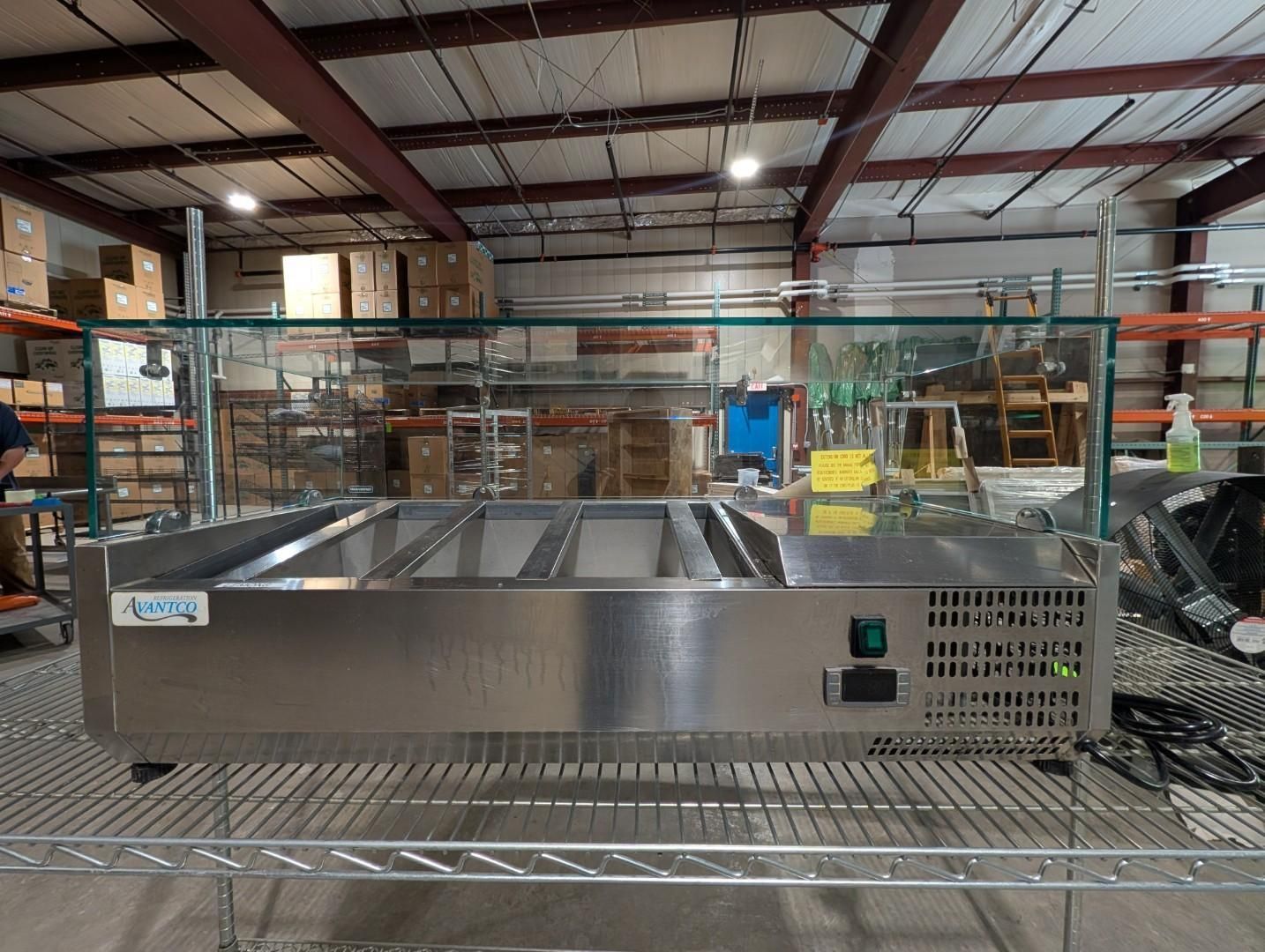 Stainless steel commercial freezer or prep table in a warehouse