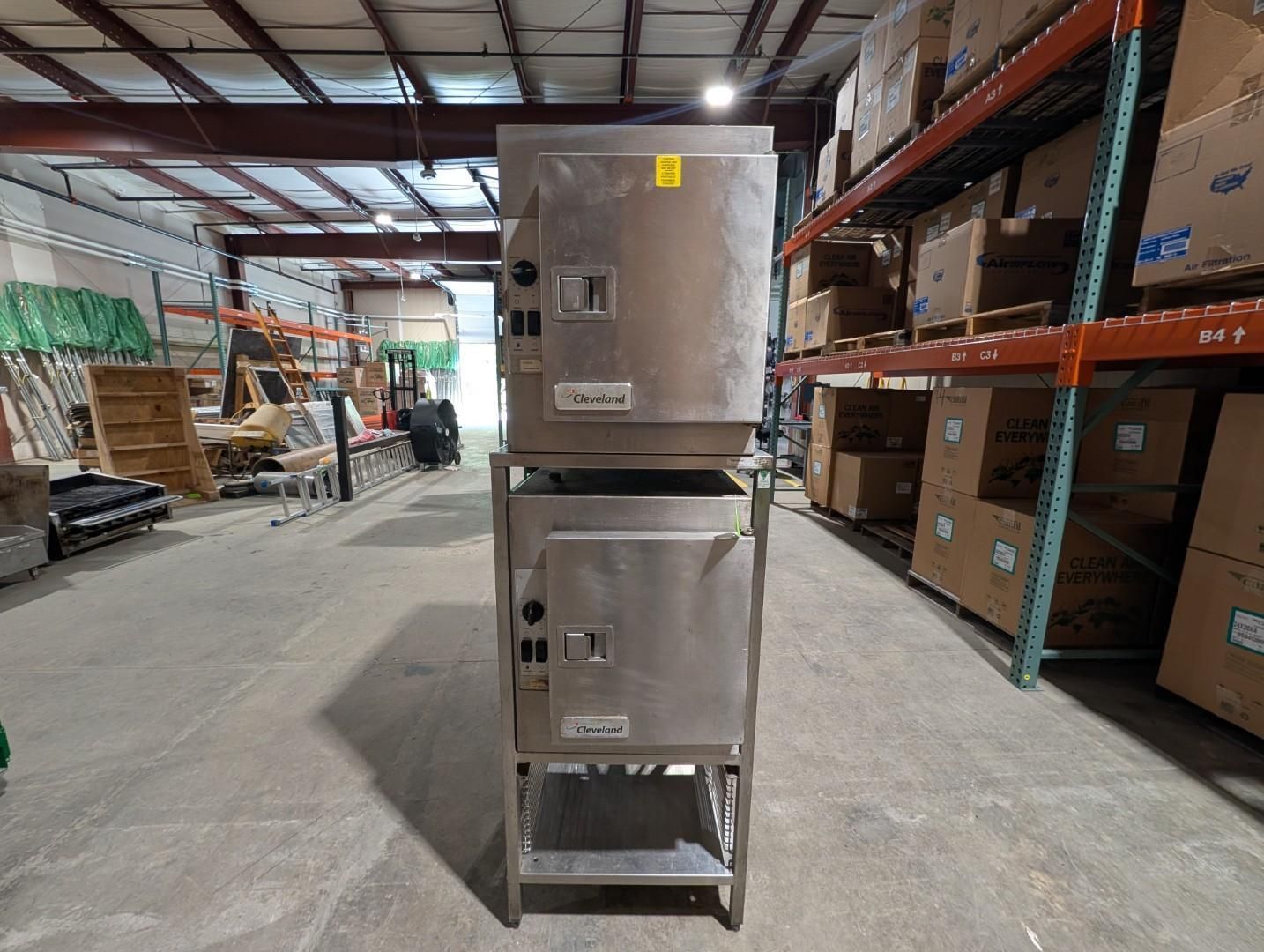 stacked stainless steel equipment on a metal cart