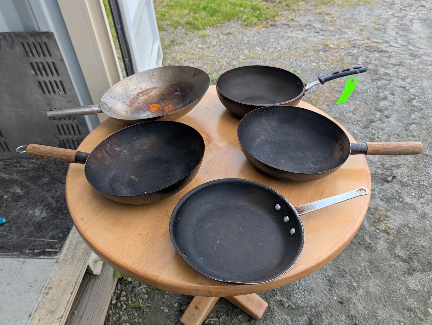 Five frying pans and a ladle