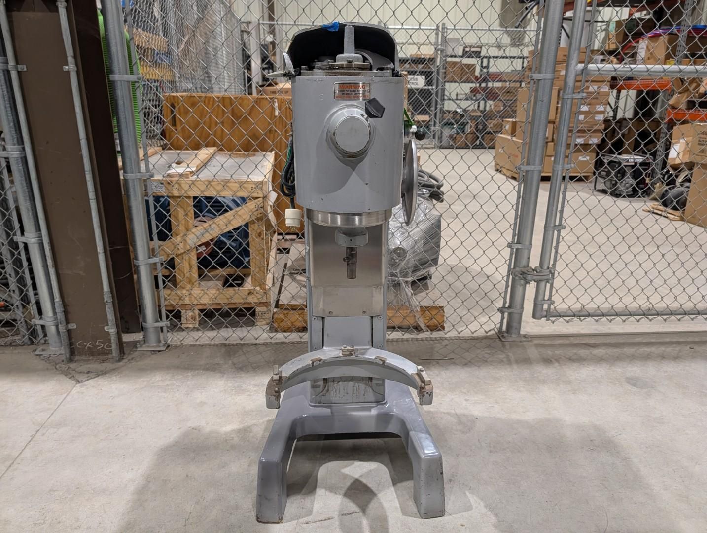 Gray industrial robot on a wheeled stand in a warehouse
