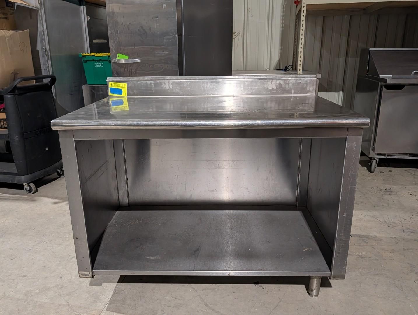 Stainless steel worktable on casters in a commercial kitchen or prep area.