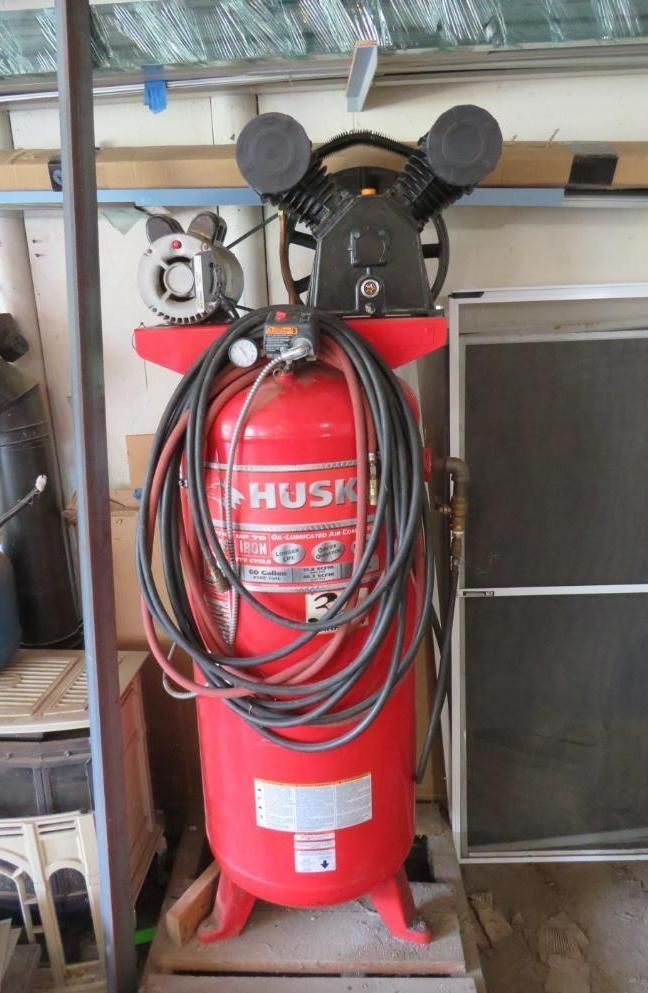 Red Husky air compressor with black hoses and a silver motor.