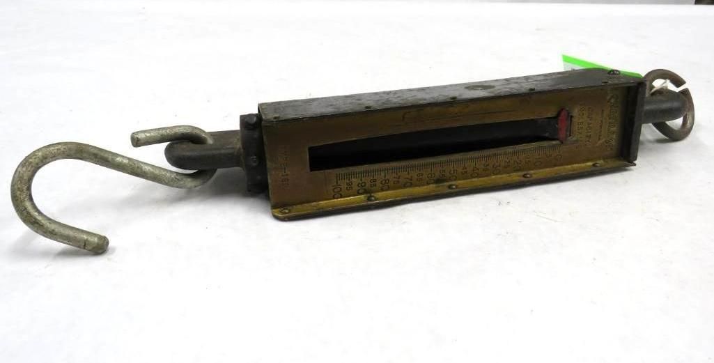 Handheld spring scale with hook for hanging items and ring for holding.